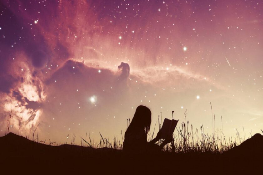 girl reading her dream journal under the stars